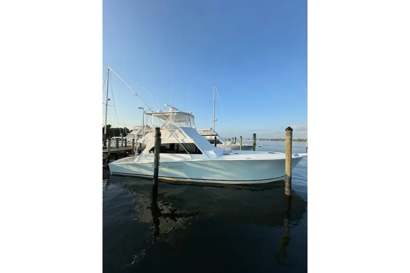 Slide: The Image of 1998 Post 50 yacht docked at marina under clear blue sky. - 6