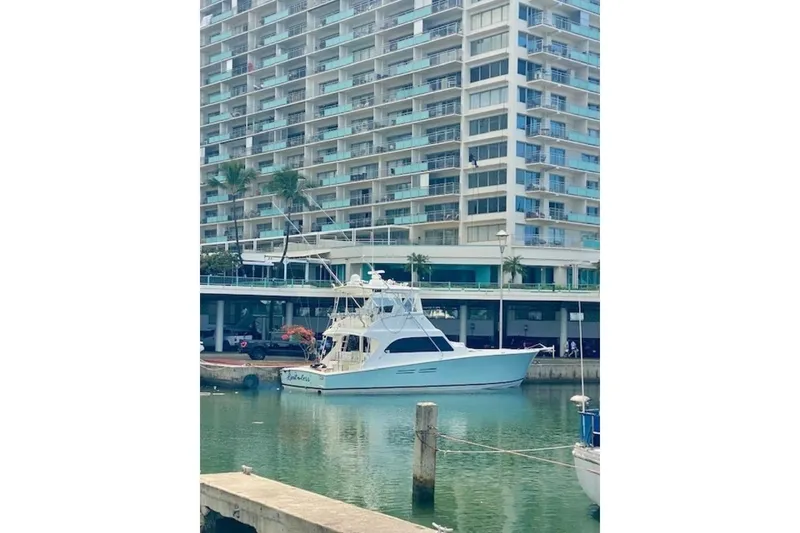 Slide: The Image of Luxury yacht docked near high-rise building, Post 50 model, 1998. - 14