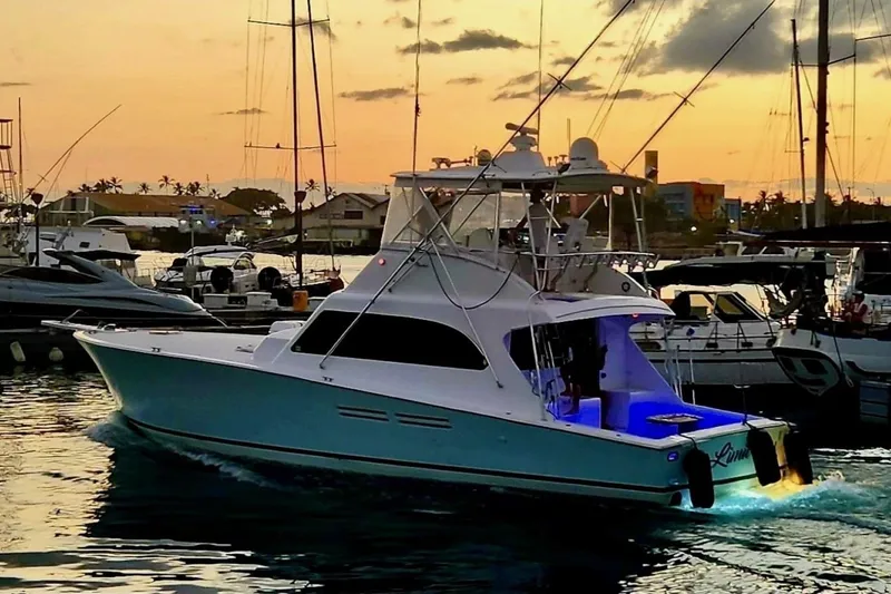 Slide: The Image of A 1998 Post 50 yacht in a marina at sunset, with illuminated deck. - 16