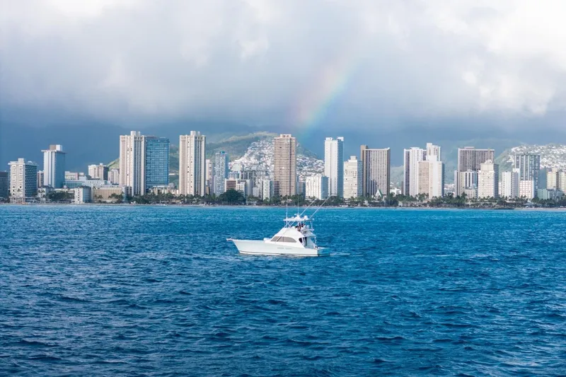 Slide: The Image of Boat on ocean with city skyline and rainbow in background, Post 50 model, 1998. - 18