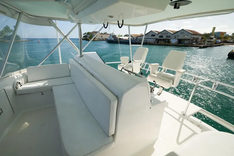 Slide: The Image of Luxurious 1998 Post 50 yacht interior with white seating, overlooking marina. - 19
