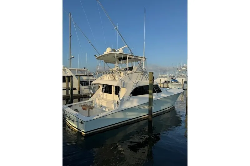 Slide: The Image of 1998 Post 50 yacht docked at marina under clear blue sky. - 5