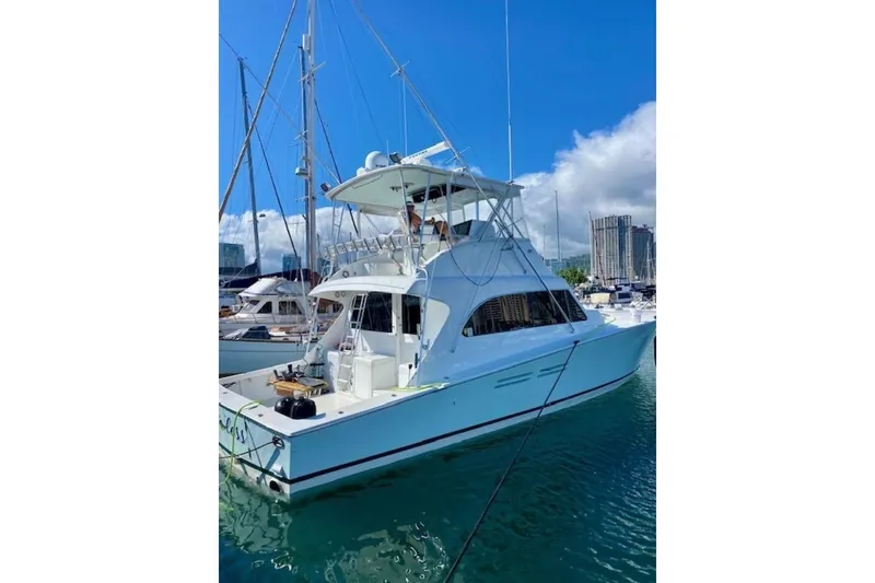 Slide: The Image of 1998 Post 50 yacht docked in marina under clear blue sky. - 7