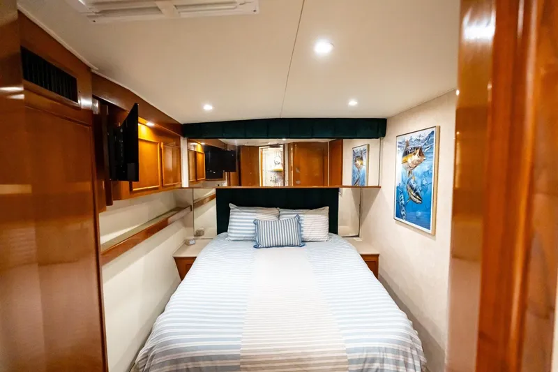 Slide: The Image of Luxurious cabin interior of a 1998 Post 50 yacht with cozy bed and marine artwork. - 9