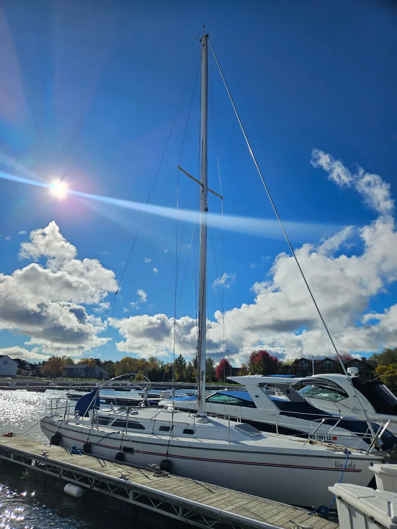 Slide: The Image of 1995 Catalina 36 MkII sailboat docked under sunny sky. - 2