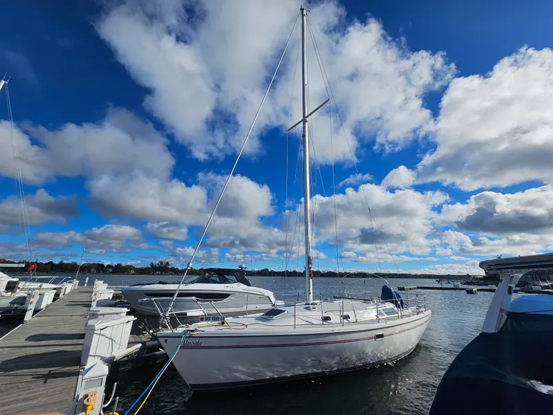 Slide: The Image of 1995 Catalina 36 MkII sailboat docked under blue sky. - 4