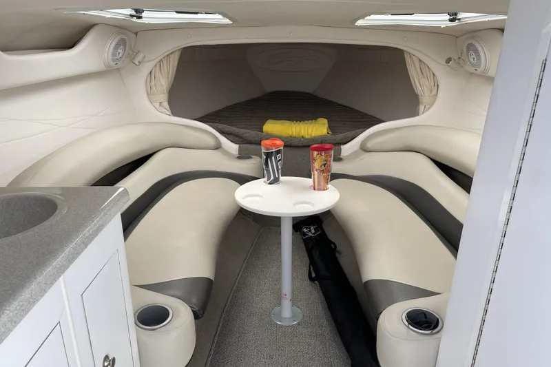 Slide: The Image of Interior of a 2000 Baja 33 Outlaw boat with seating and table setup. - 15