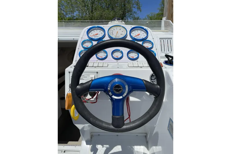 Slide: The Image of Steering wheel and gauges of a 2000 Baja 33 Outlaw boat cockpit. - 7