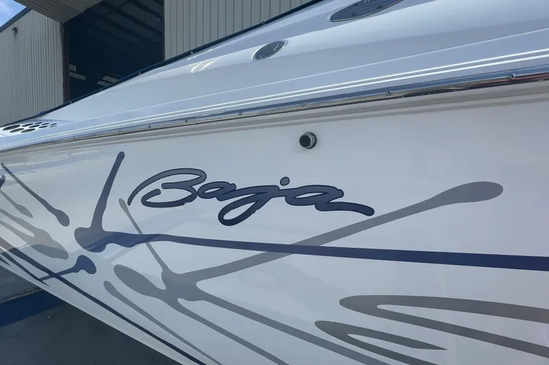 Slide: The Image of 2000 Baja 33 Outlaw boat with sleek graphics and logo detail. - 9
