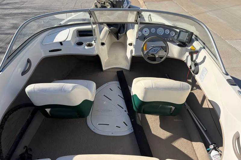 Slide: The Image of 2007 Tahoe Q4 boat interior with steering wheel, dashboard, and seating. - 2