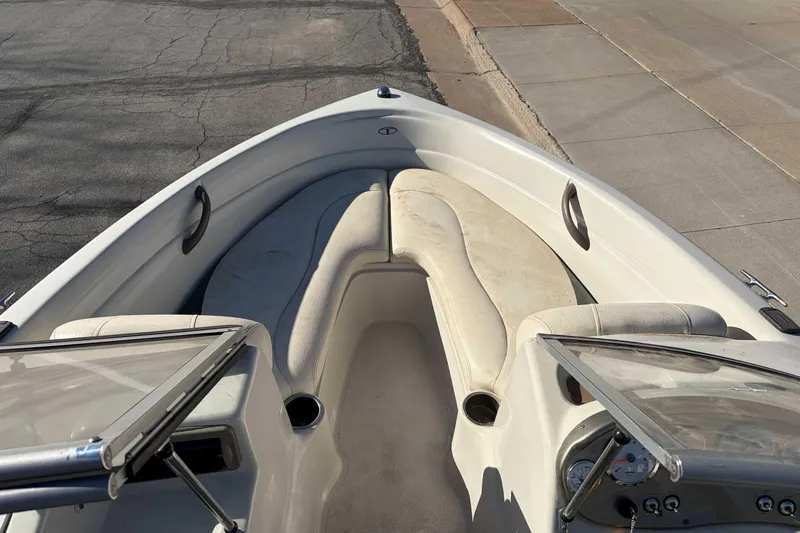 Slide: The Image of 2007 Tahoe Q4 boat interior with beige seating and dashboard view. - 3