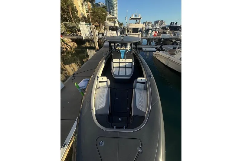 Slide: The Image of 2025 Mystic Powerboats M4200 docked, showcasing sleek design and luxurious seating. - 3