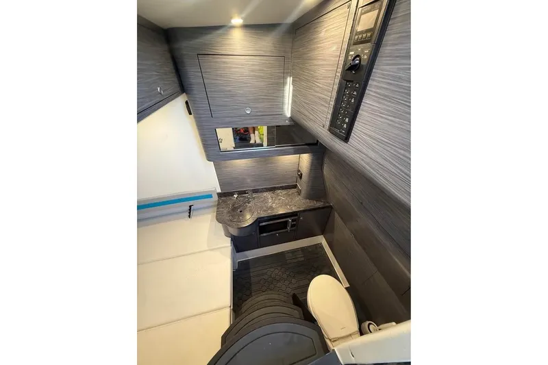 Slide: The Image of 2025 Mystic Powerboats M4200 interior cabin with modern amenities and sleek design. - 8