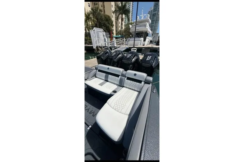 Slide: The Image of 2025 Mystic Powerboats M4200 with luxurious seating and powerful engines docked at marina. - 9
