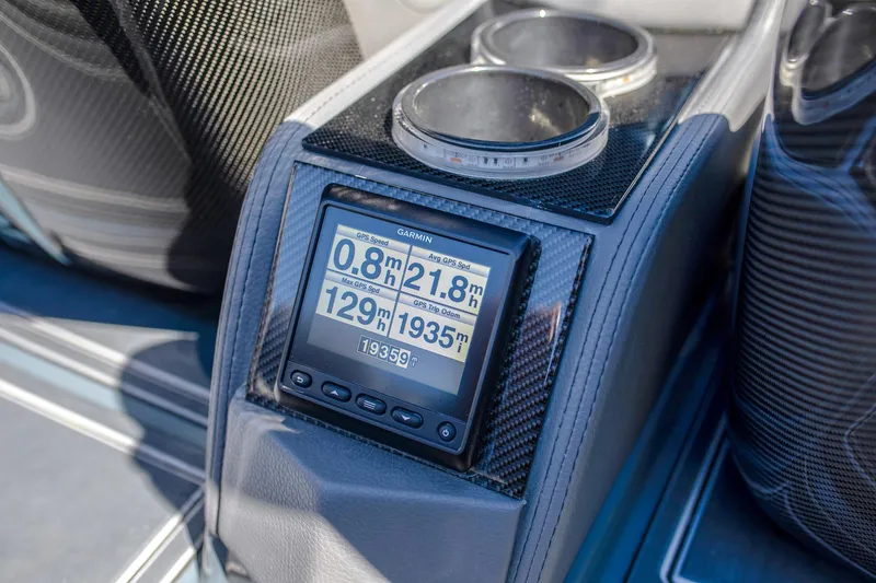 Slide: The Image of Dashboard of 2024 MTI 390X boat with digital display and cup holders. - 12