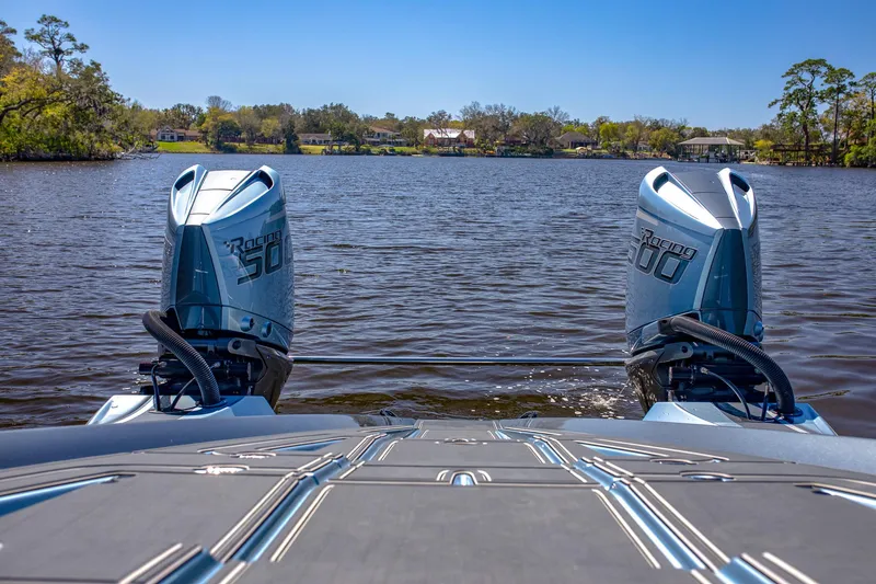 Slide: The Image of 2024 MTI 390X boat with twin Mercury 300 engines on a serene lake. - 18