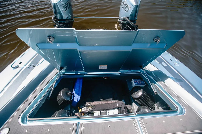 Slide: The Image of Open storage compartment on 2024 MTI 390X boat with visible equipment. - 20