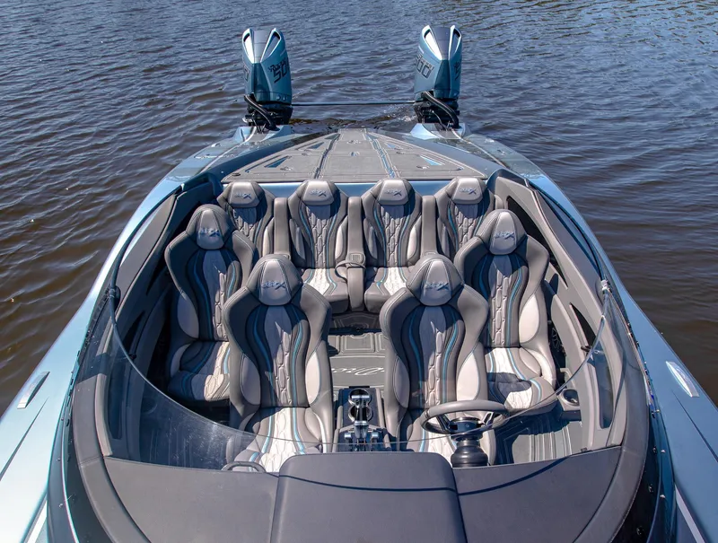 Slide: The Image of 2024 MTI 390X boat with luxurious seating on calm water. - 26