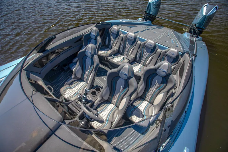 Slide: The Image of 2024 MTI 390X luxury speedboat with spacious seating, dual engines, and sleek design on the water. - 27