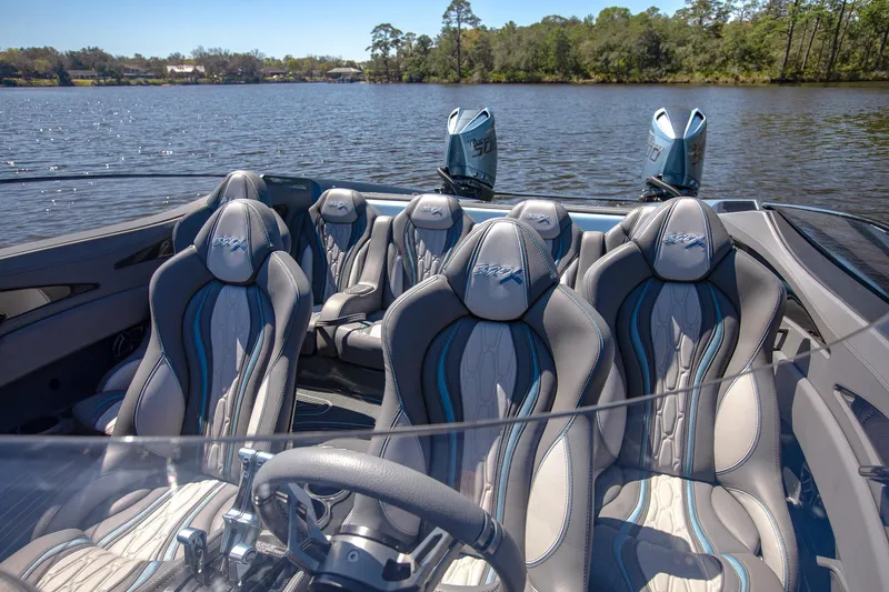 Slide: The Image of 2024 MTI 390X boat interior with luxury seating on a serene lake. - 28
