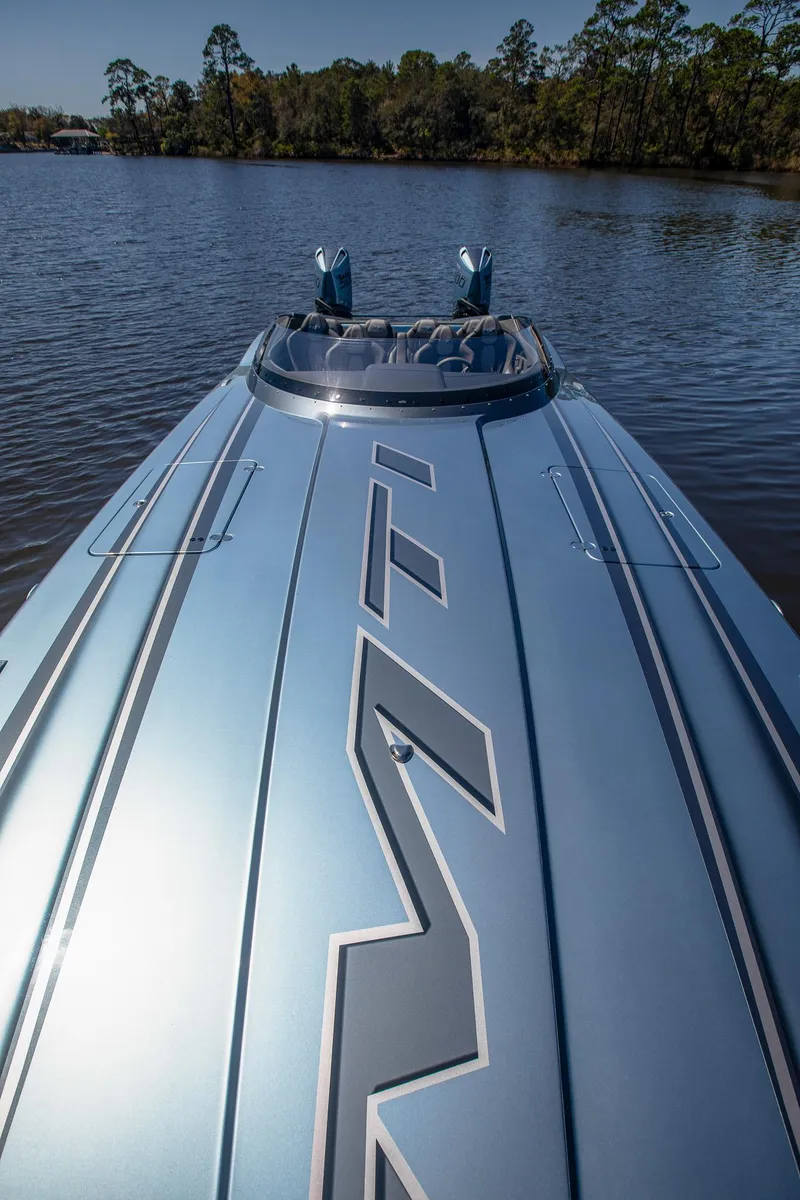 Slide: The Image of 2024 MTI 390X speedboat on calm lake with sleek design and modern features. - 31