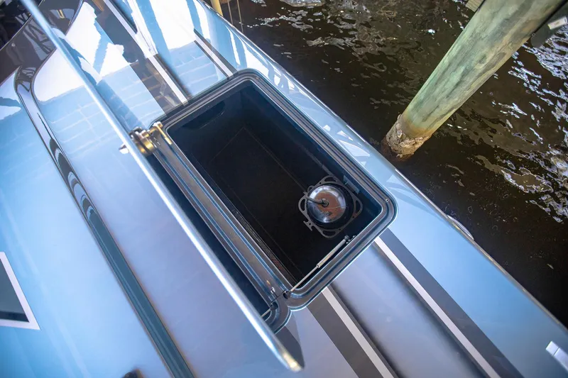 Slide: The Image of Open storage compartment on 2024 MTI 390X boat, dockside view. - 33