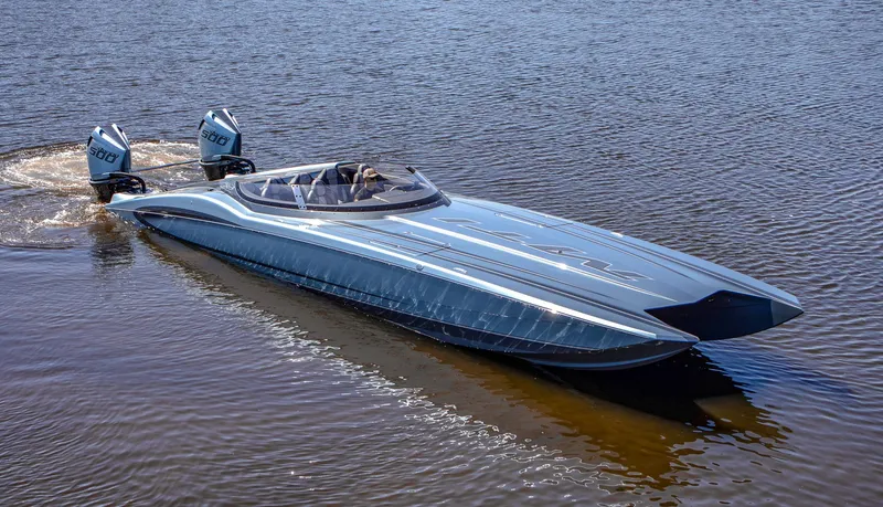 Slide: The Image of 2024 MTI 390X speedboat on water, featuring sleek design and dual outboard engines. - 7