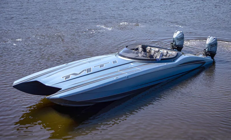 Slide: The Image of 2024 MTI 390X speedboat with dual engines on calm water. - 8