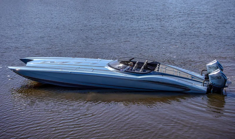 Slide: The Image of 2024 MTI 390X powerboat on water, sleek design, light blue color, dual engines. - 9