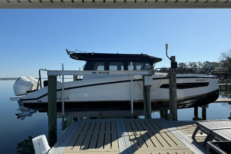 Slide: The Image of 2025 Navan C30 boat docked, featuring sleek design and Mercury outboard engines. - 1