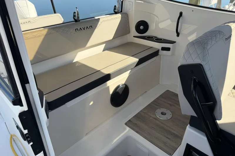 Slide: The Image of Interior of 2025 Navan C30 boat with beige seating and cup holders. - 11