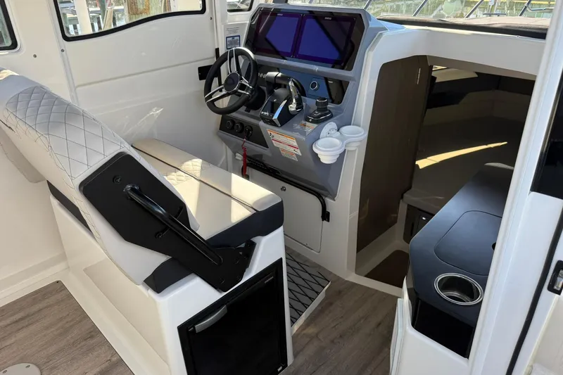 Slide: The Image of Interior of 2025 Navan C30 boat with modern helm and seating. - 12