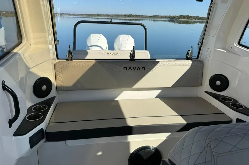 Slide: The Image of Interior of 2025 Navan C30 boat with seating and cup holders, overlooking calm water. - 13