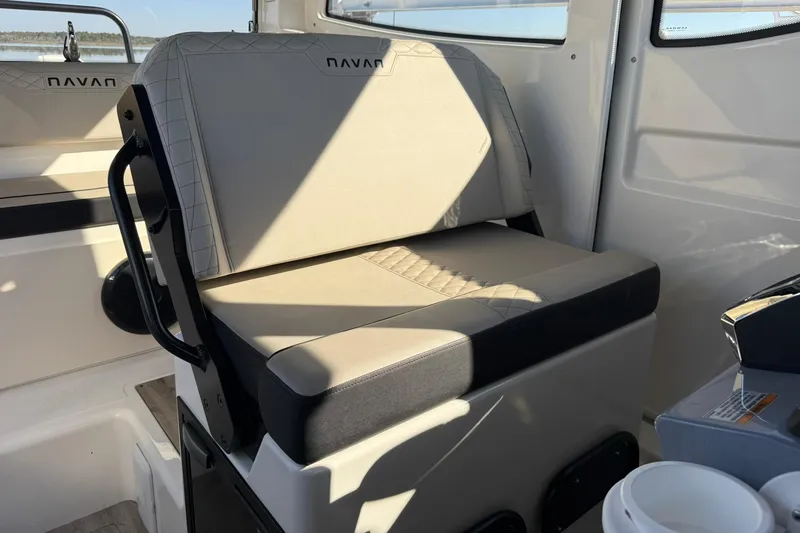 Slide: The Image of 2025 Navan C30 interior seat with beige upholstery and black accents. - 14