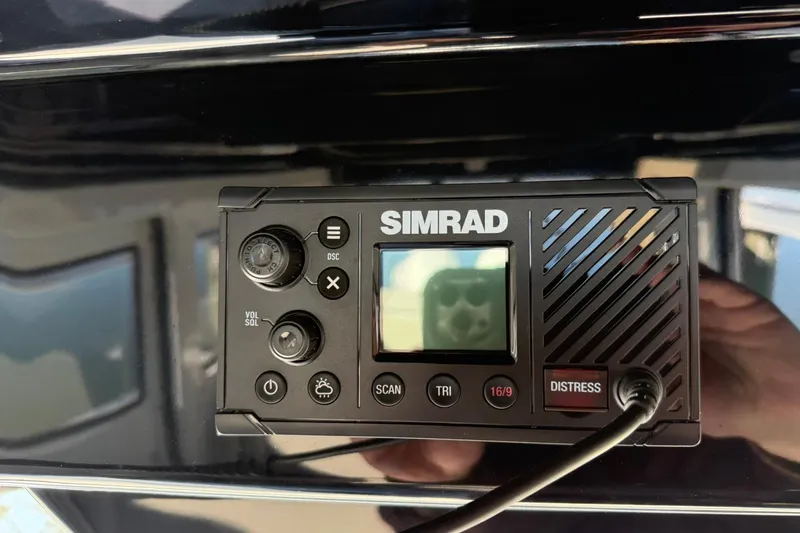 Slide: The Image of Simrad marine radio on Navan C30, 2025 model, featuring distress button and display. - 18