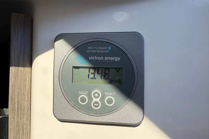 Slide: The Image of Victron Energy battery monitor displaying 13.4 volts in Navan C30, 2025 model. - 22