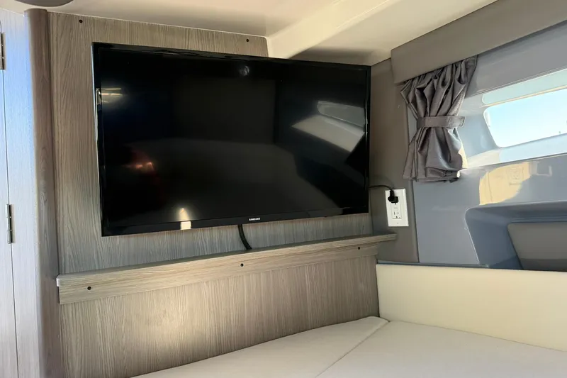 Slide: The Image of Flat-screen TV in 2025 Navan C30 interior with modern wood paneling. - 24