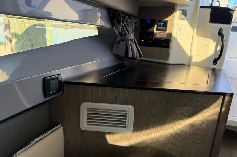 Slide: The Image of Interior of 2025 Navan C30, featuring modern control panel and sleek cabinetry design. - 25