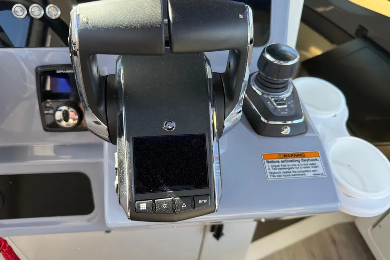 Slide: The Image of Control panel of 2025 Navan C30 boat with joystick and warning label. - 26