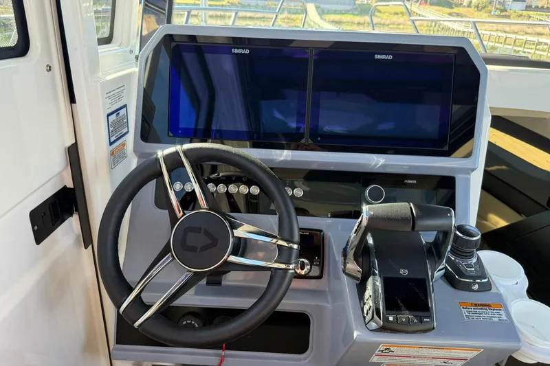 Slide: The Image of Helm of 2025 Navan C30 boat with advanced navigation controls and dual Simrad displays. - 27