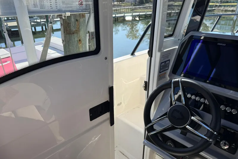 Slide: The Image of Interior view of 2025 Navan C30 boat cockpit with steering wheel and navigation display. - 29