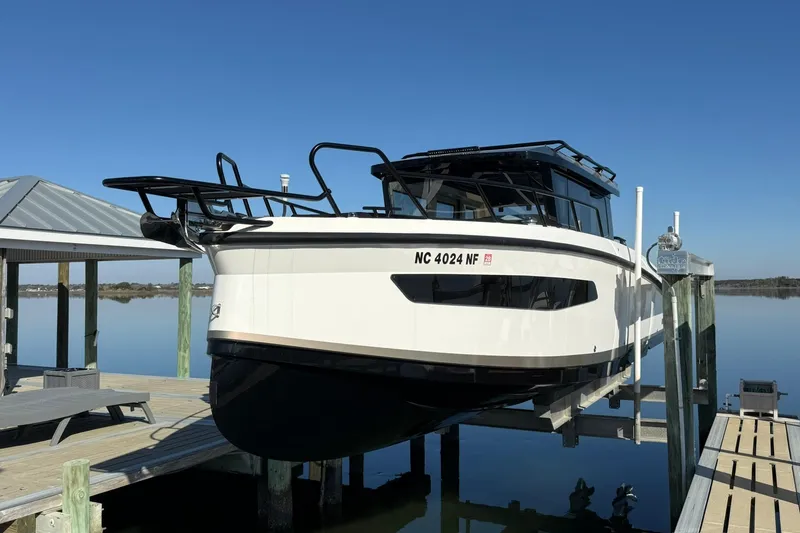Slide: The Image of Navan C30 2025 boat docked on a lift, clear blue sky background. - 3