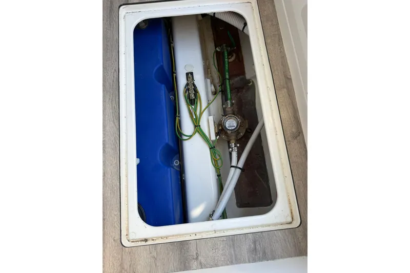 Slide: The Image of Underfloor compartment of 2025 Navan C30 with visible wiring and plumbing components. - 30