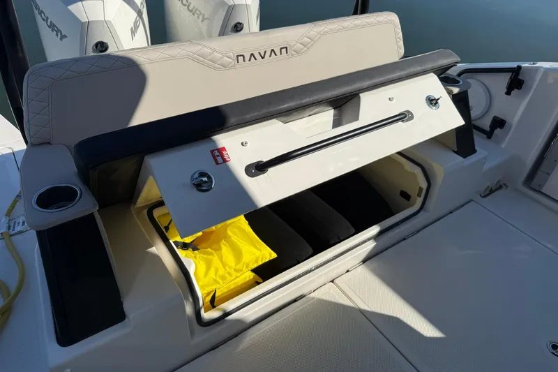 Slide: The Image of 2025 Navan C30 boat storage compartment with open hatch, revealing interior and yellow life jacket. - 34