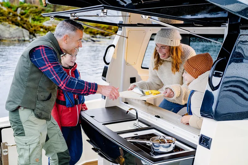 Slide: The Image of Manufacturer Provided Image: Family enjoying outdoor cooking on a 2025 Navan C30 boat. - 40