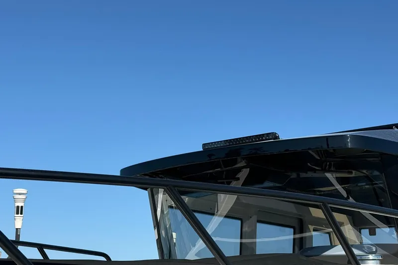 Slide: The Image of 2025 Navan C30 boat with sleek design against clear blue sky. - 5