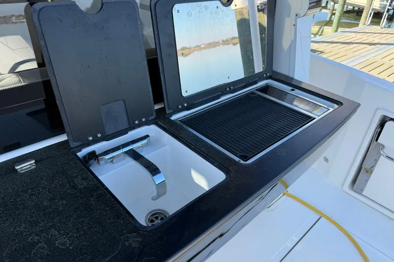 Slide: The Image of Outdoor sink and grill setup on Navan C30, 2025 model, with water view. - 8