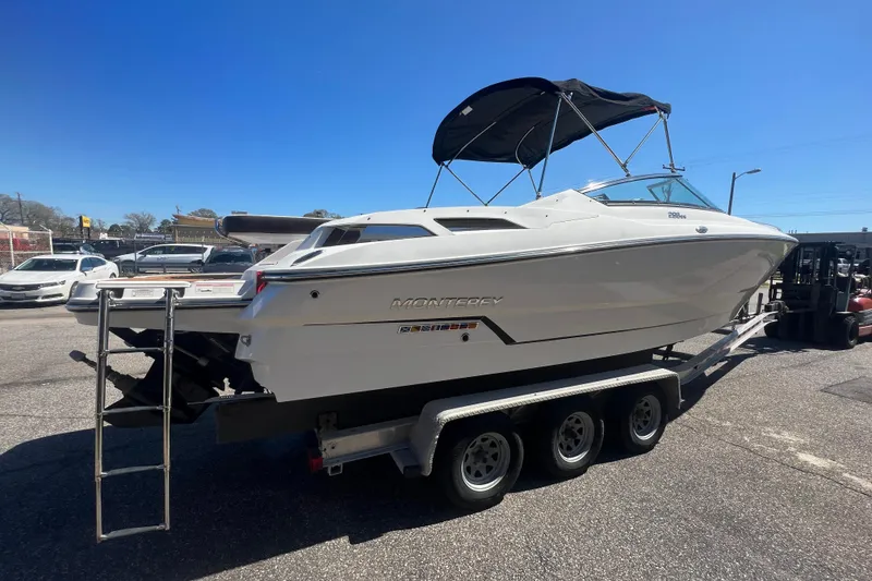 Slide: The Image of 2017 Monterey 298SS Super Sport boat on a trailer under clear blue sky. - 13