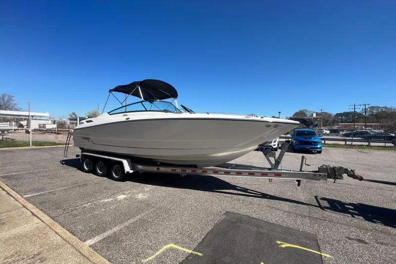 Slide: The Image of 2017 Monterey 298SS Super Sport boat on trailer in parking lot under clear blue sky. - 16
