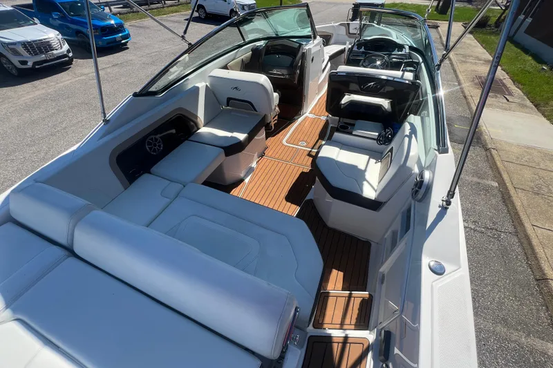 Slide: The Image of 2017 Monterey 298SS Super Sport boat interior with white seating and wood flooring. - 27